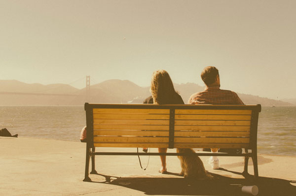 Couple sitting on a bench.